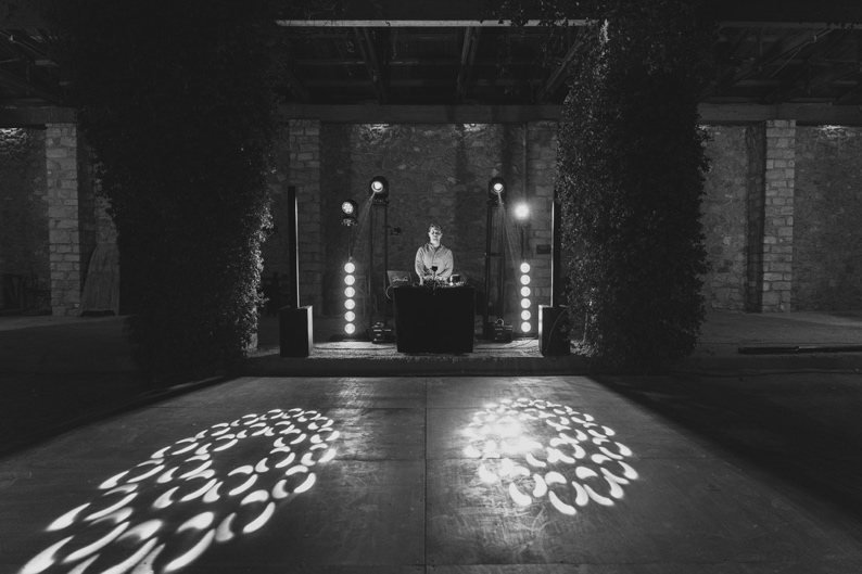 DJ booth with gobo lights on the dance floor